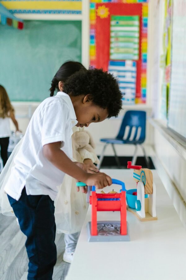 Young children playing with educational toys in a vibrant classroom setting.