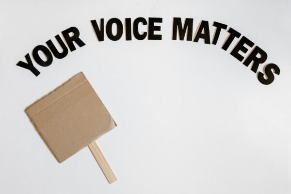 Cardboard protest sign with text 'Your Voice Matters' emphasizes empowerment and advocacy.